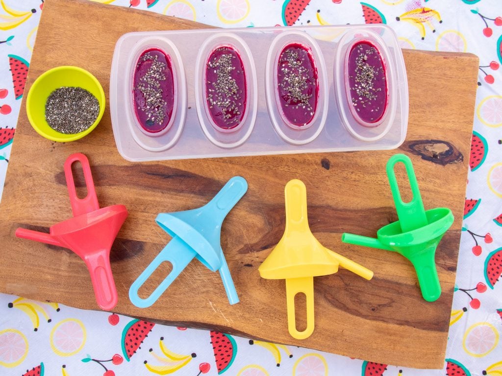 blueberry, banana, and beet juice with chia seeds in popsicles mold