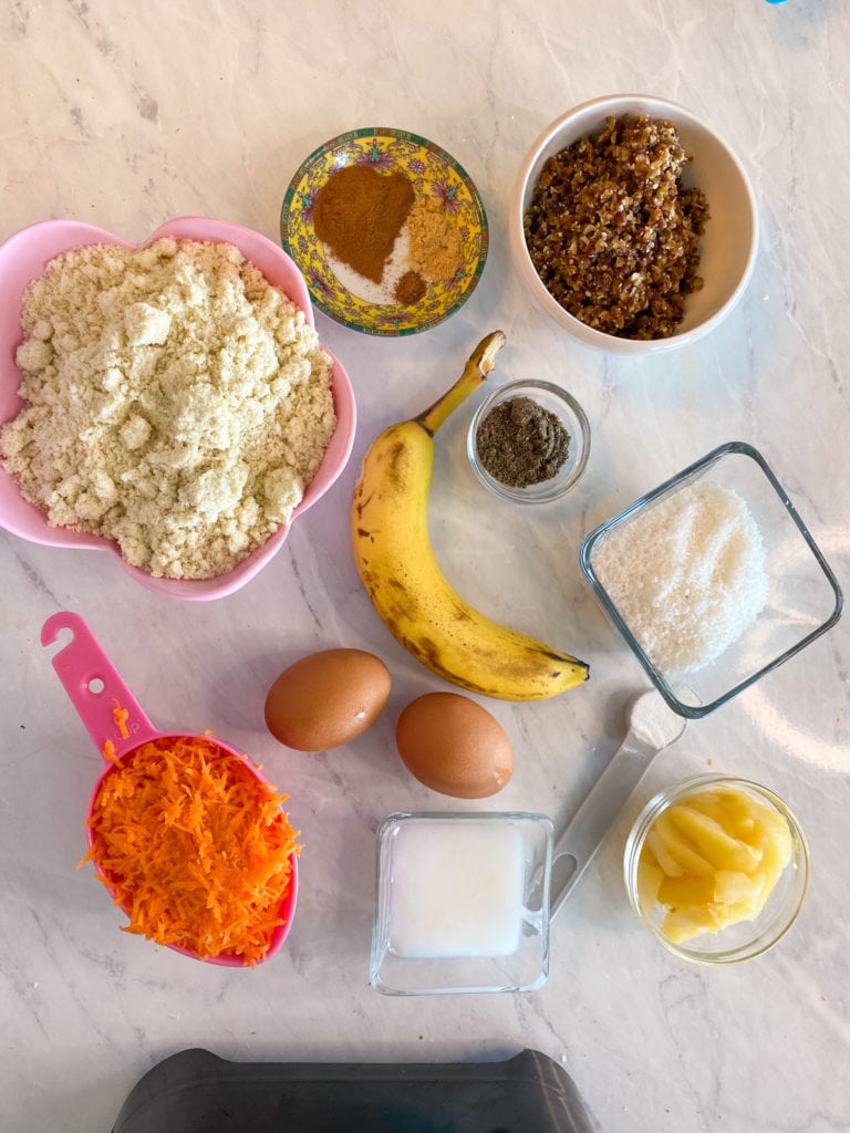 Ingredients:
- 1 cup thinly grated carrots 
- 2 cups almond flour  
- 2 eggs 
- 1.5 tsps aluminum free baking powder
- 1/4 cup homemade applesauce (steamed apples that were puréed) 
-1/3 cup mashed banana (about 1 big banana) 
- 1/4 cup + 2 Tbsps  organic coconut oil 
- 6 organic pitted dates
Coconut cream frosting 
-the cream of 1 can of coconut cream, chilled overnight 
-1 tsp maple syrup

Toppings
-shredded coconut, pulverized 
-about 6-7 dates
-1 Tbsp hemp seeds
