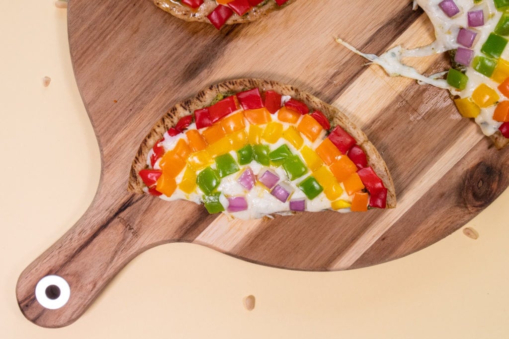 Slice of rainbow pesto pita pizza