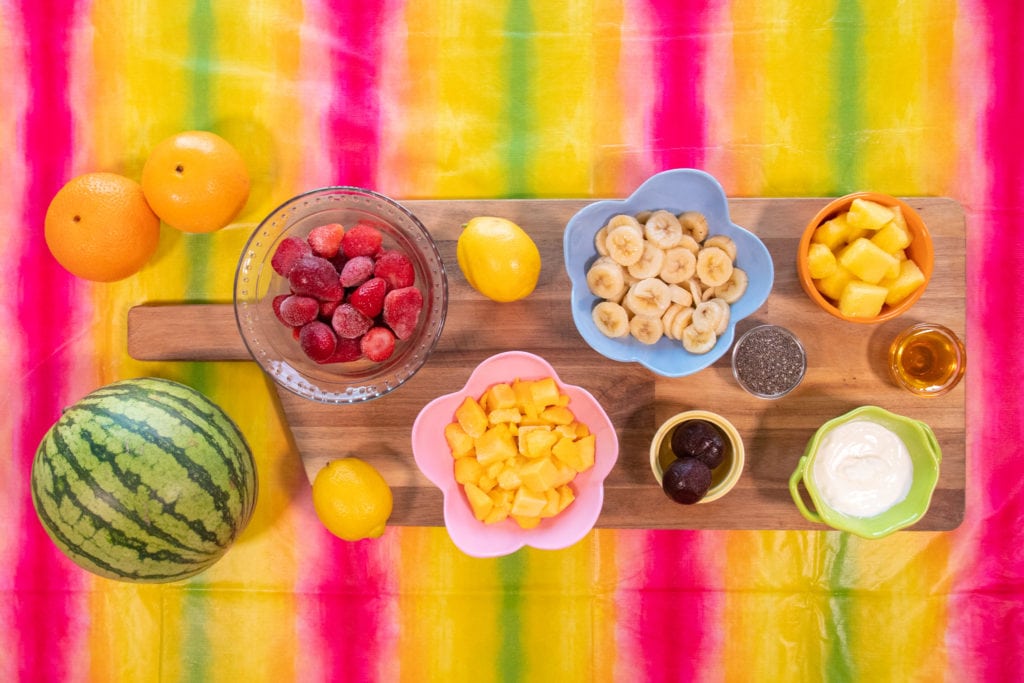 Fruits inside the tropical sunrise smoothie: watermelon, mango, orange, banana, lemon