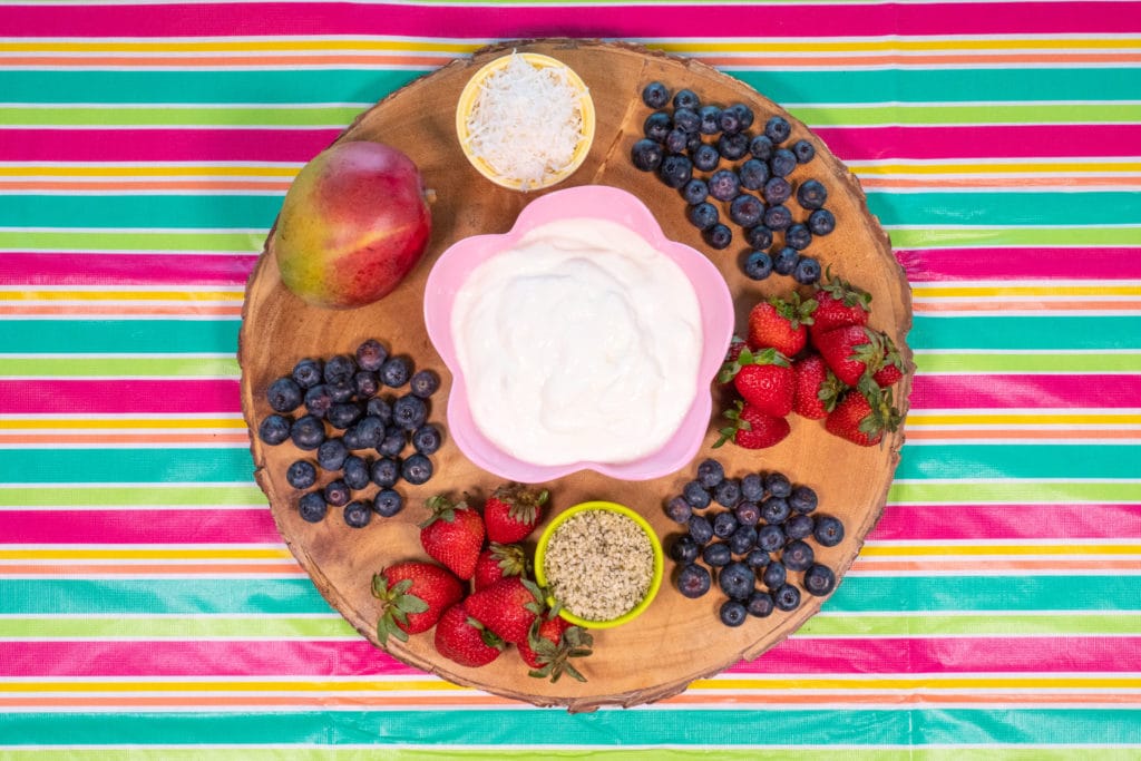 Frozen Yogurt Fruity pizza ingredients: strawberries, blueberries, mango, shredded coconut, and yogurt