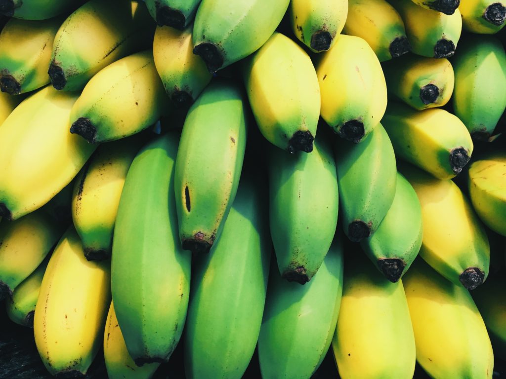 Picture of ripening bananas, with some green at the center