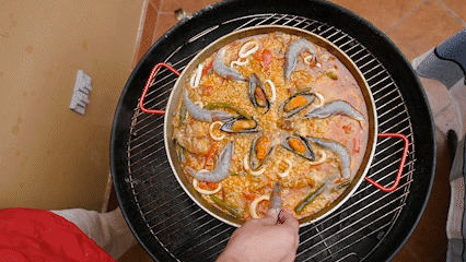 Adding shrimp to paella