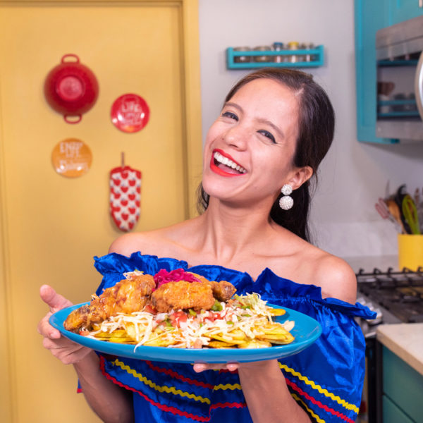 La Cooquette smiling showing the Honduran pollo con tajadas