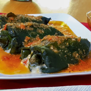 Stuffed poblano peppers served in a white platter