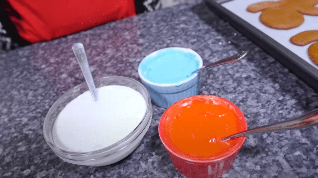 Three containers with colored royal icing.