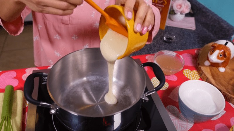 Pouring condensed milk into a pot