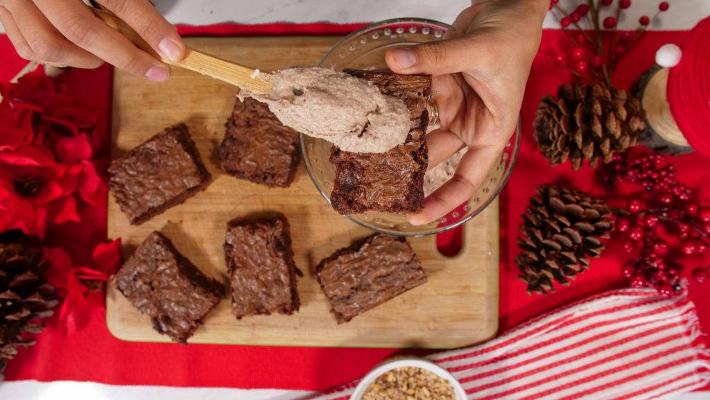 Adding frosting to Mexican Hot Chocolate brownies